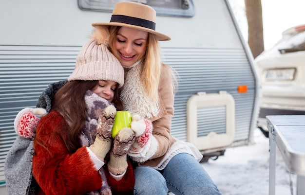 Medium shot mother and girl outdoors