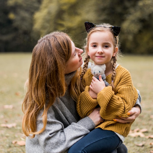 Free photo medium shot mother holding girl