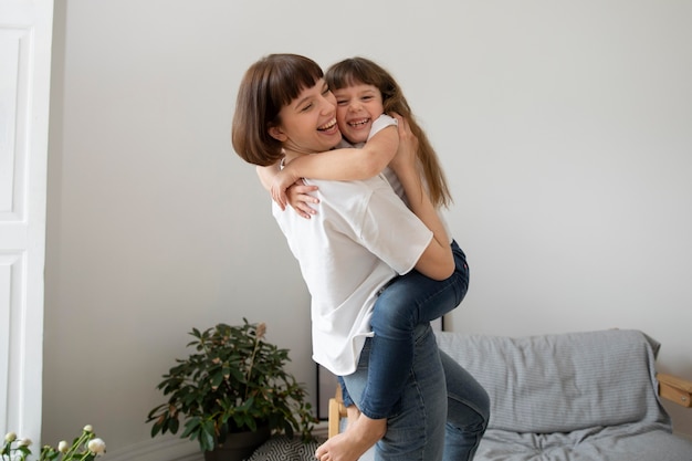 Medium shot mother holding girl