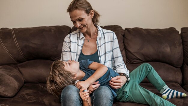 Medium shot mother holding kid indoors