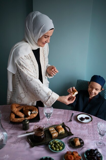 Medium shot mother and kid eating