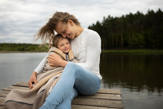 Medium shot mother and kid outdoors