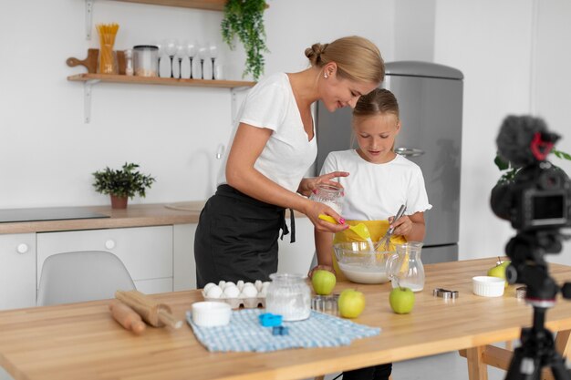 Medium shot mother pouring sugar