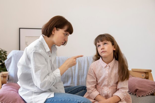 Medium shot mother scolding girl