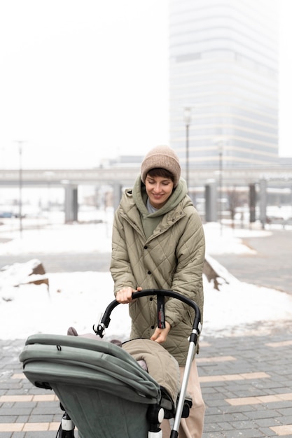 Medium shot mother walking with stroller