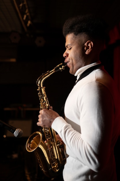 Free Photo medium shot musician playing the saxophone