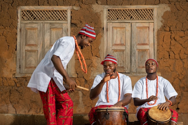 Free photo medium shot nigerian men making music