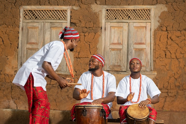 Free Photo medium shot nigerian men playing music