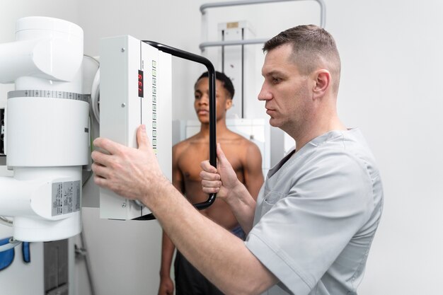 Free photo medium shot nurse giving scan to patient