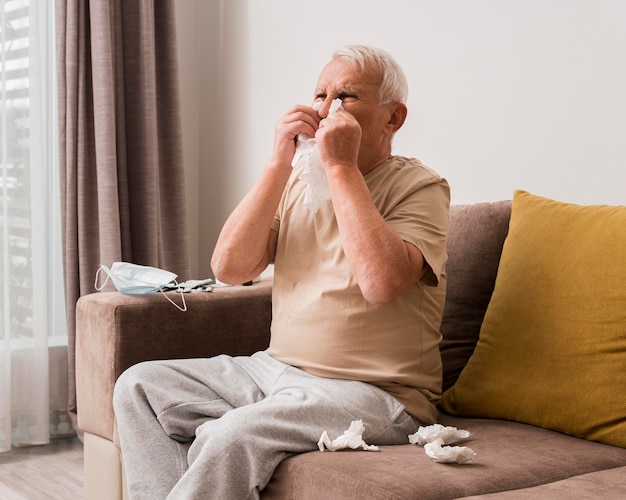 Medium shot old man blowing his nose