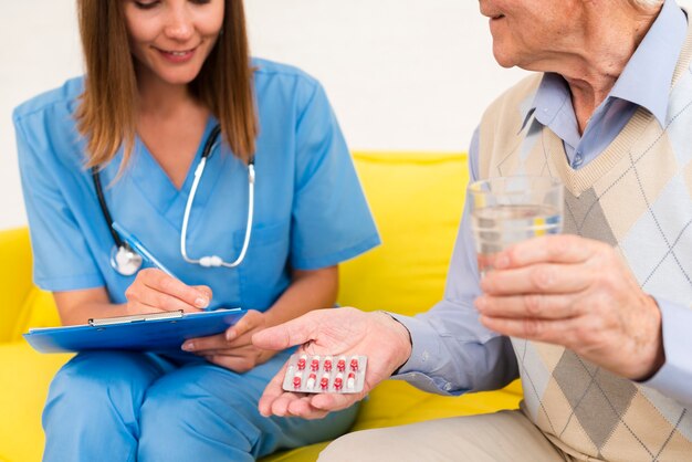 Medium shot old man holding his pills