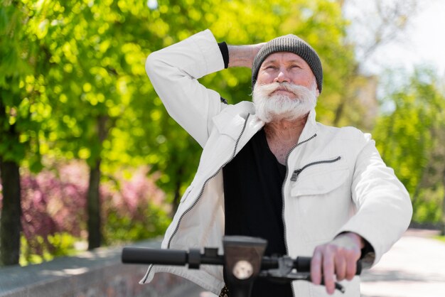 Medium shot old man on scooter