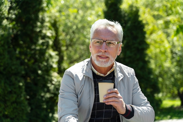 Medium shot old man with coffee cup