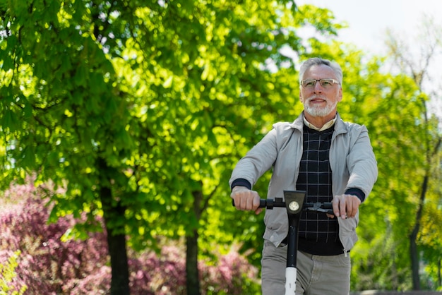 Medium shot old man with scooter outdoors