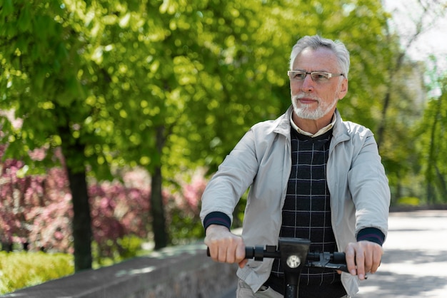 Medium shot old man with scooter