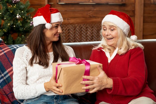 Medium shot old woman receiving a gift