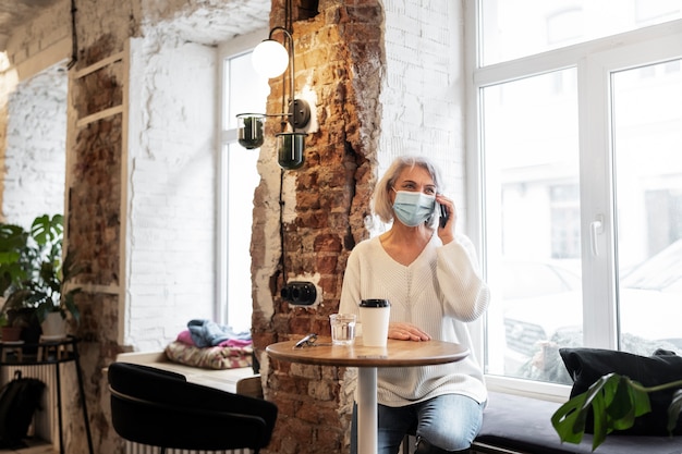 Free Photo medium shot old woman talking on phone