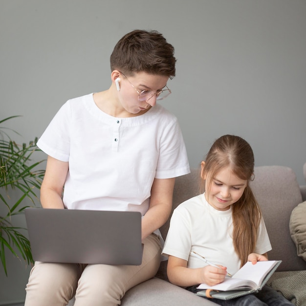 Medium shot parent looking at notebook