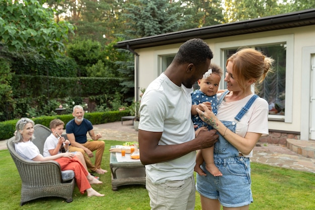 Medium shot parents holding baby