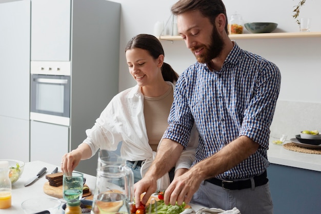 Medium shot people cooking together