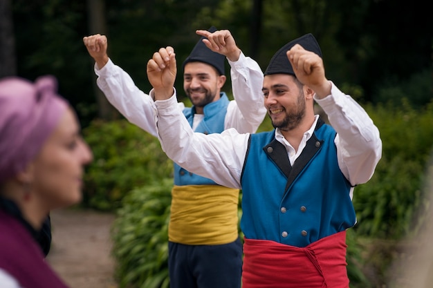 Medium shot people dancing folk