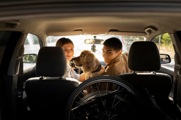 Medium shot people at dog in car