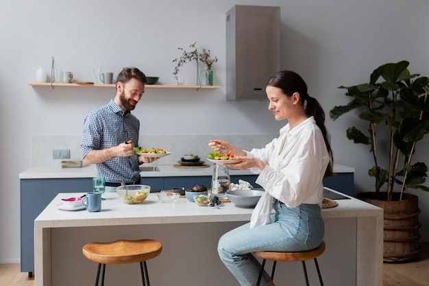 Medium shot people eating salad