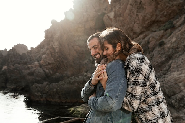 Medium shot people hugging outdoors