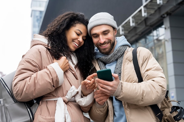 Medium shot people looking at phone