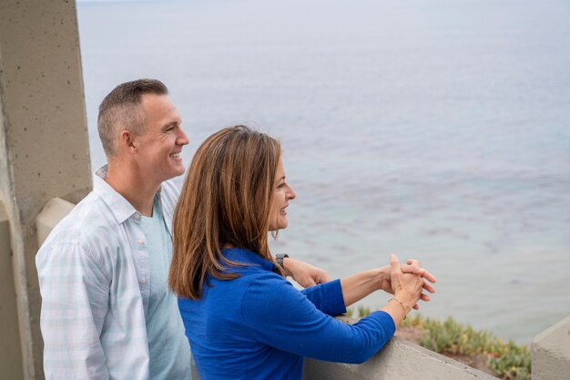 Medium shot people looking at sea