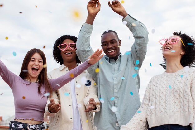 Medium shot people partying with confetti