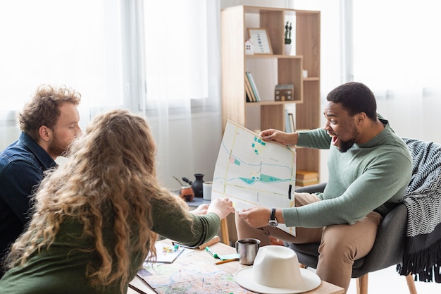 Free photo medium shot people planning trip with map