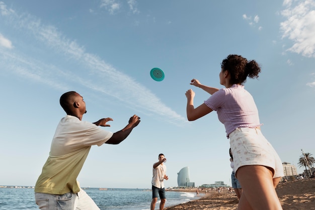 Medium shot people playing at beach