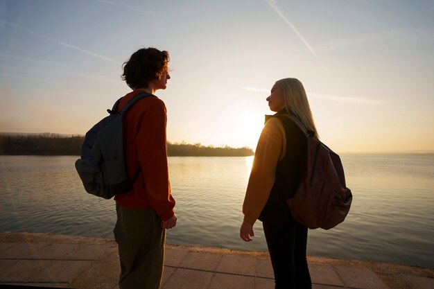 Medium shot people posing at sunset