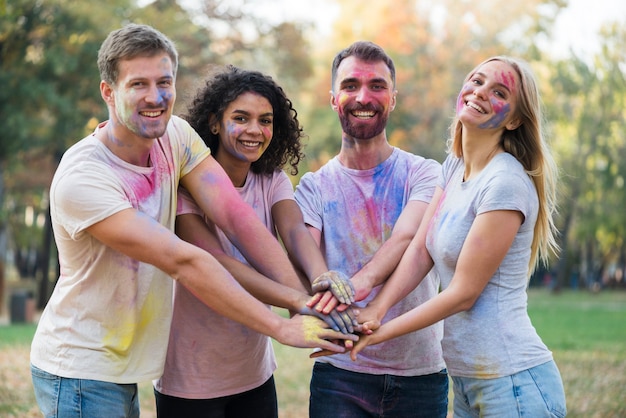 Medium shot of people putting their hands together