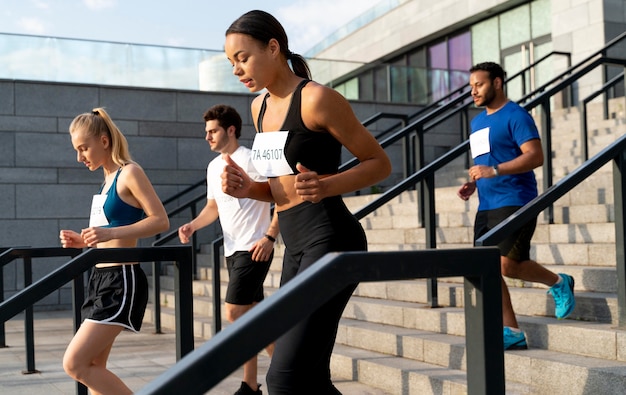 Medium shot people running together on stairs