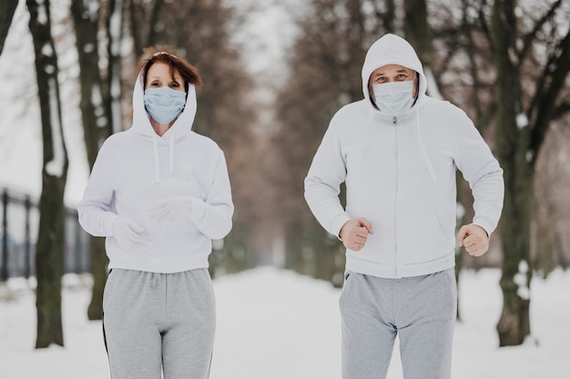 Medium shot people running with masks