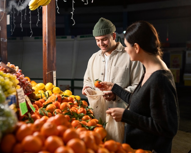 Medium shot people shopping for food