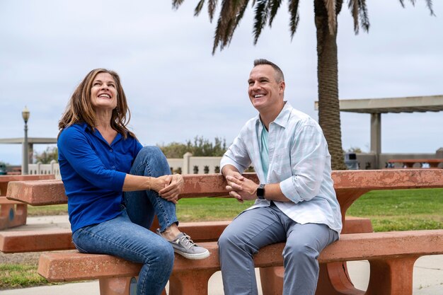 Medium shot people sitting on bench