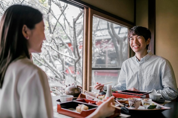 Medium shot people sitting at table