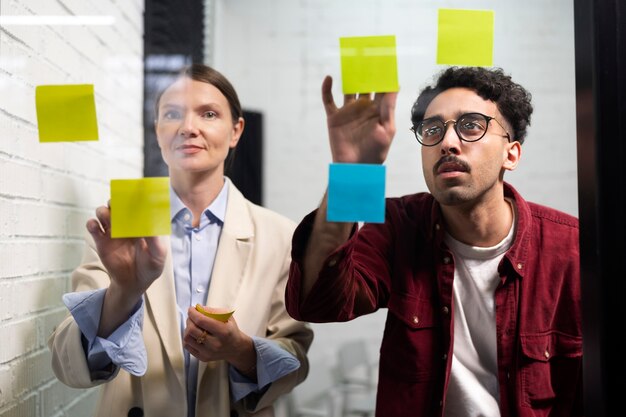 Medium shot people sticking post its