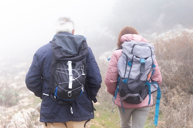 Medium shot people wearing backpacks