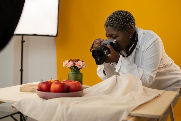 Medium shot photographer taking fruit photos