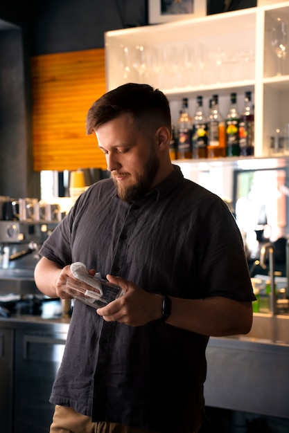 Medium shot plus-size man working as barista