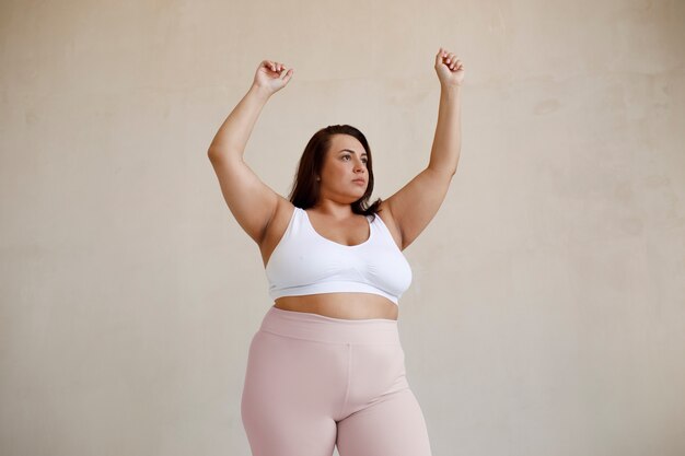 Medium shot plus size model posing in studio