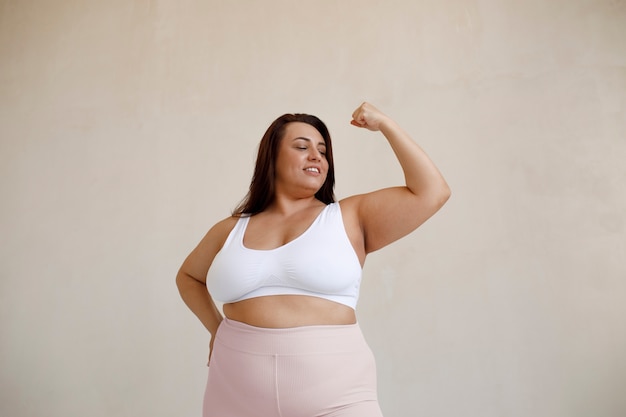 Medium shot plus size model posing in studio