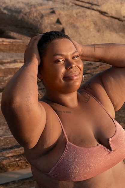 Medium shot plus-size woman posing at seaside