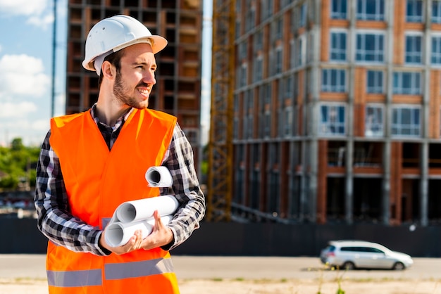 Free Photo medium shot portrait of engineer holding plans