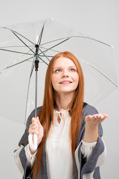 Medium shot pretty model holding umbrella