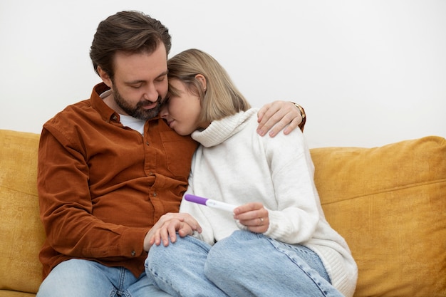 Medium shot sad couple on couch